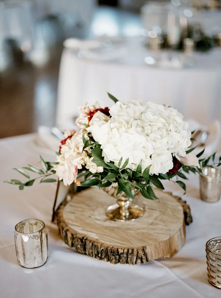 Fall florals in pink, peach and red shades with a rustic twist. Dahlias, roses, hydrangea, greenery