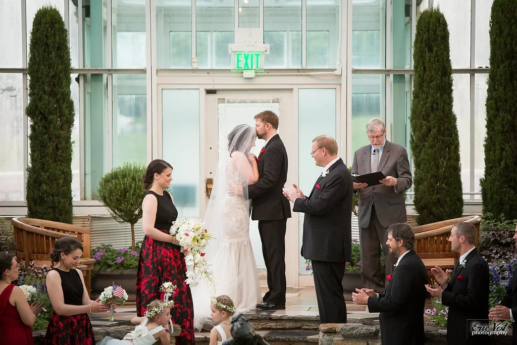 Bride and groom's first kiss for Como Park Zoo and Conservatory wedding ceremony