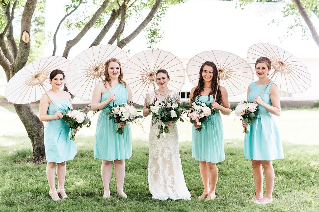 Bride and bridesmaids with parisols