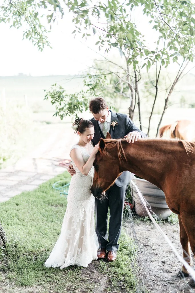 Bride and groom with horse at Red Barn Farm Wedding