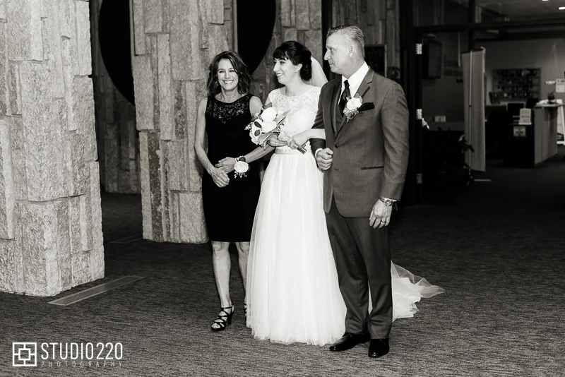 Bride walking down the aisle with parents