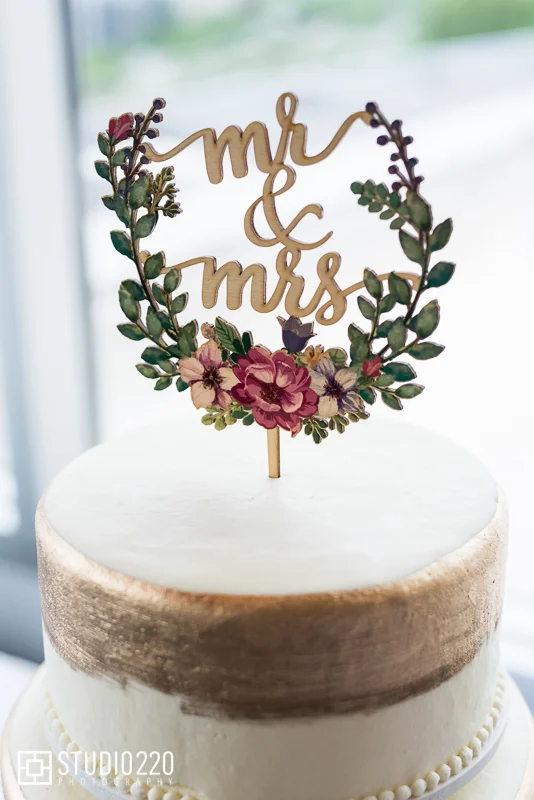 Gold painted cake with script topper