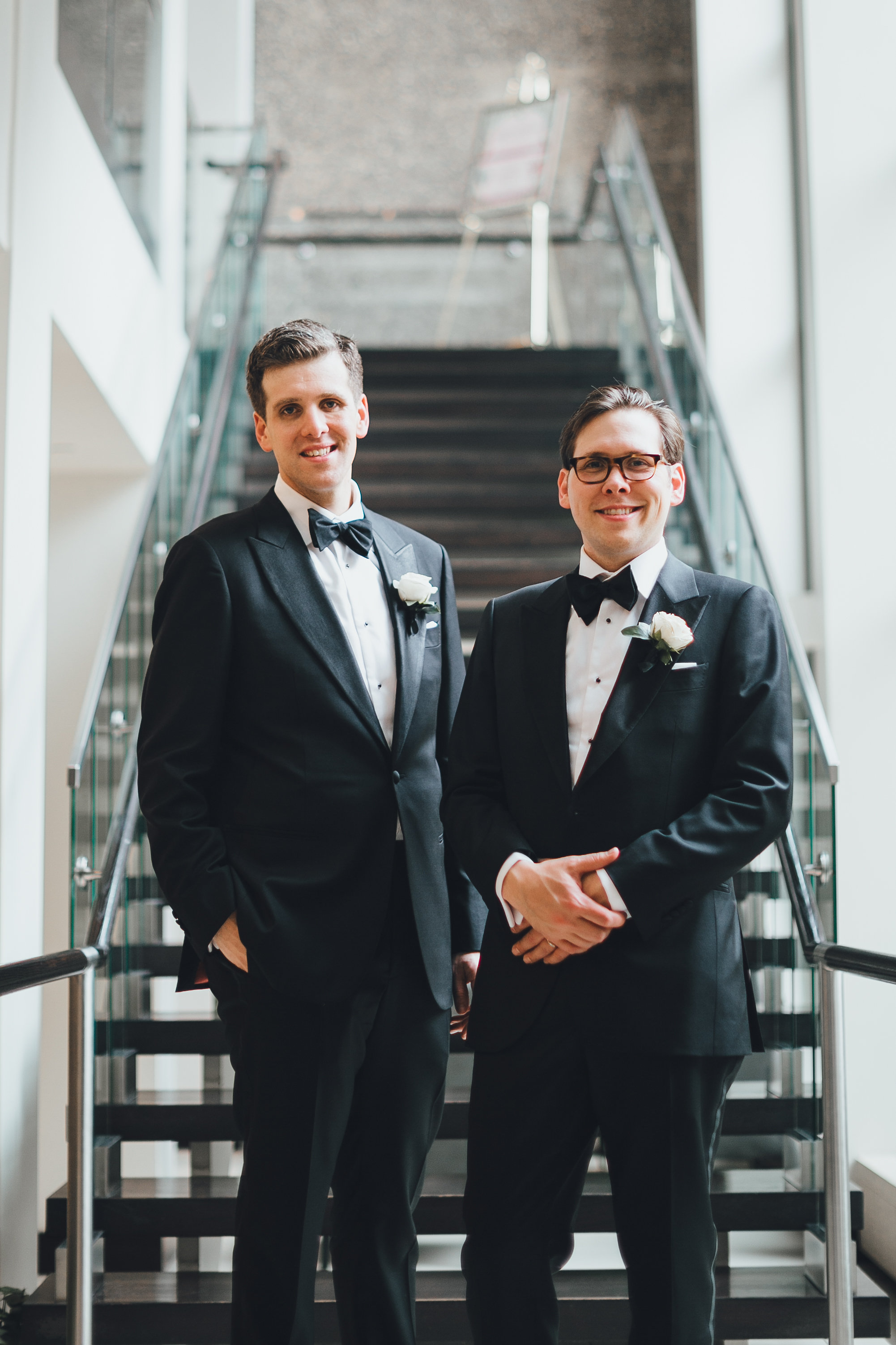 Two grooms smiling for the camera
