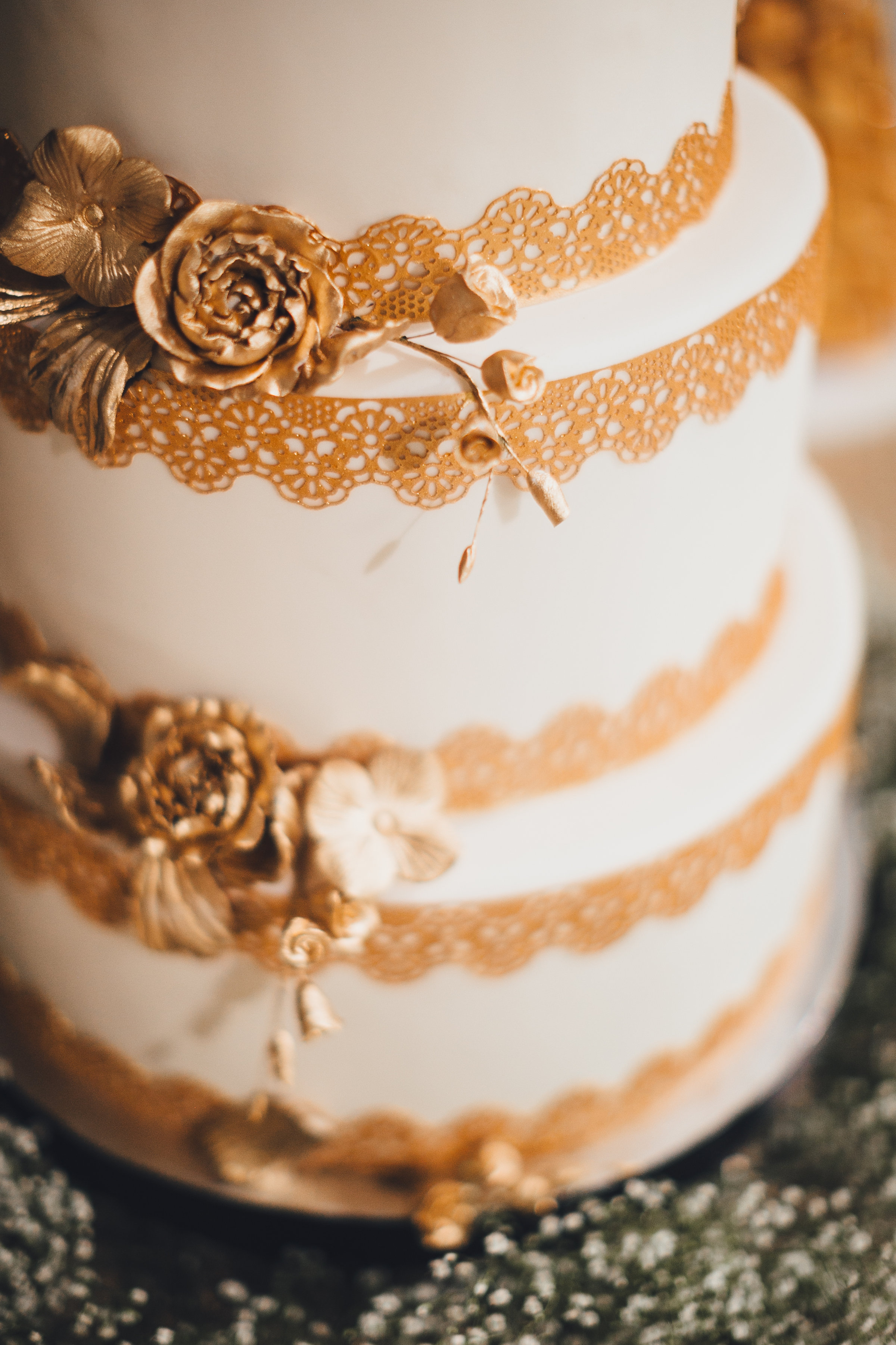 White wedding cake with gold lace details