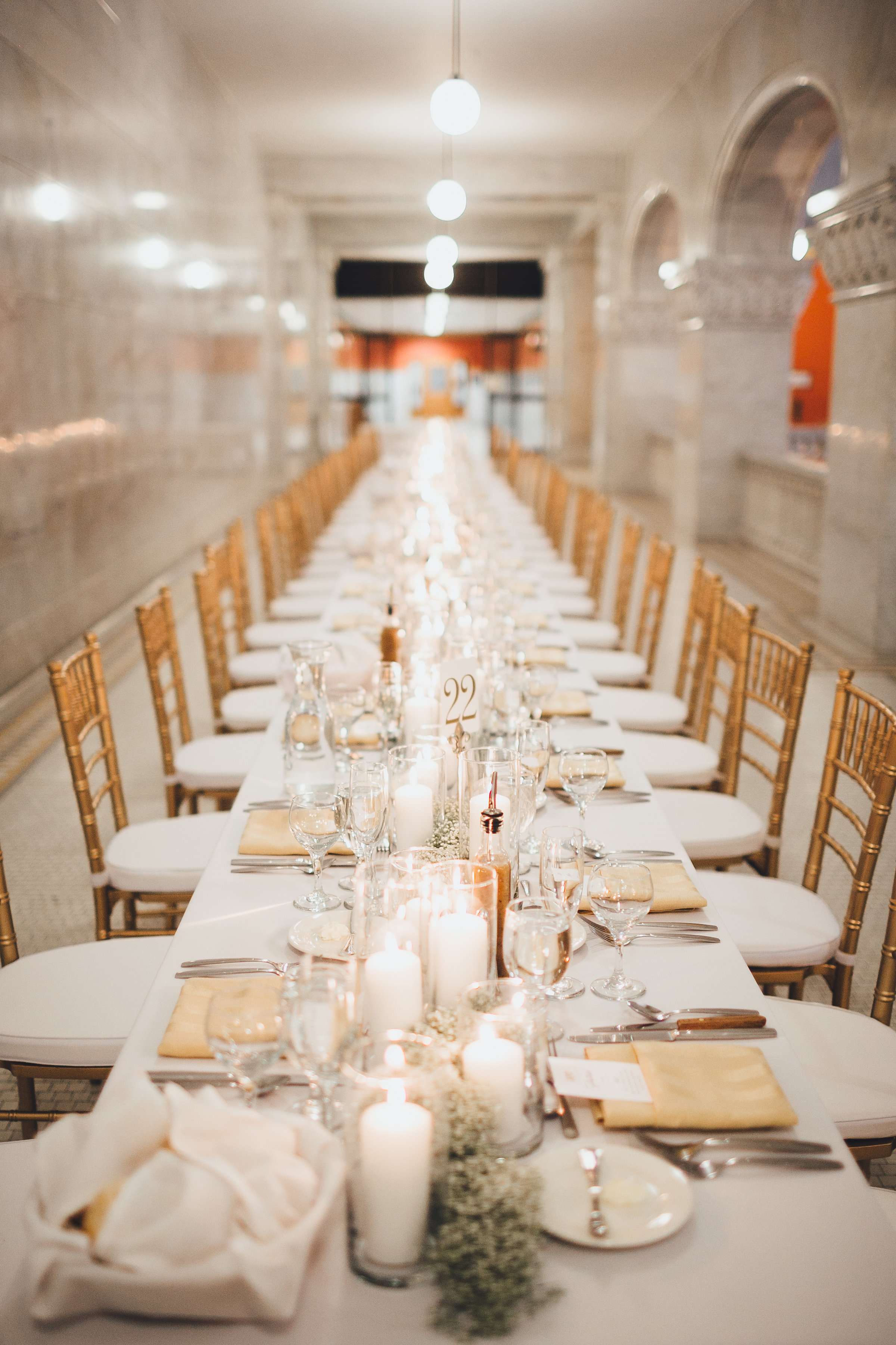 Long reception table with gold chiavari cahirs