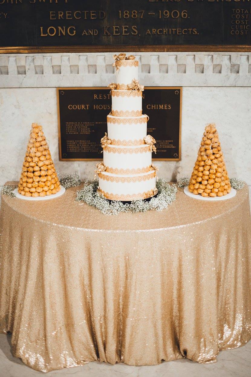 Four tiered white and gold wedding cake