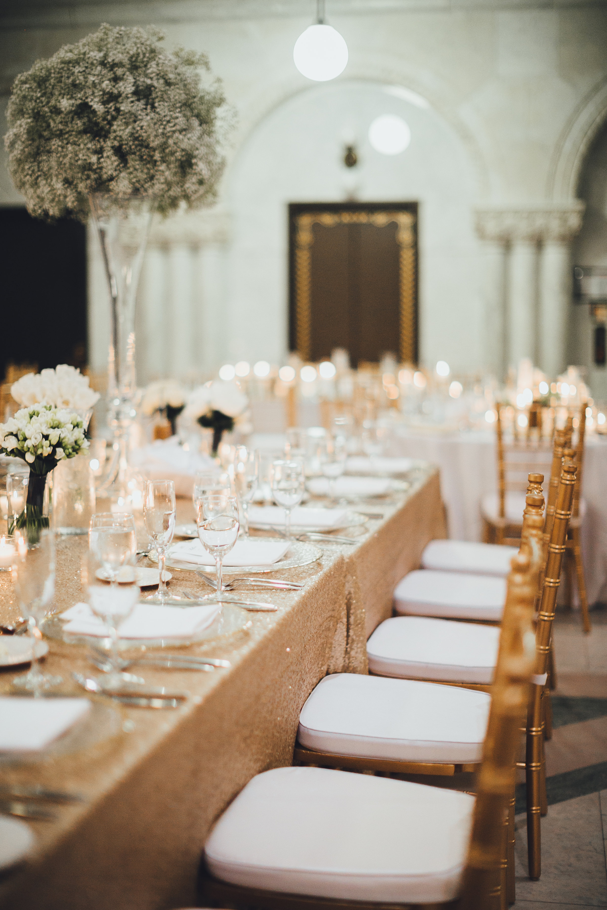 Head table with tall baby's breath arrangements
