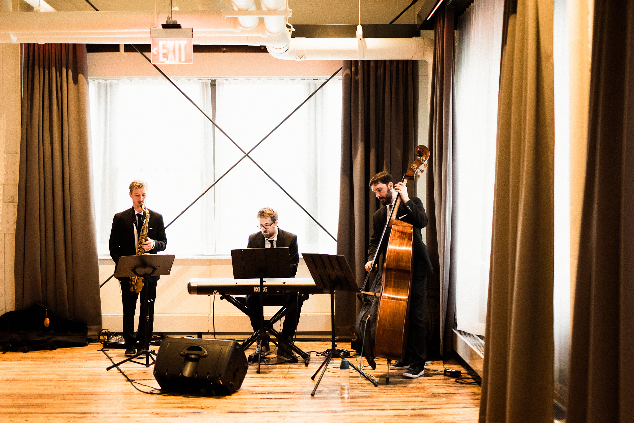 saxophonist, pianist, and bassist at a wedding