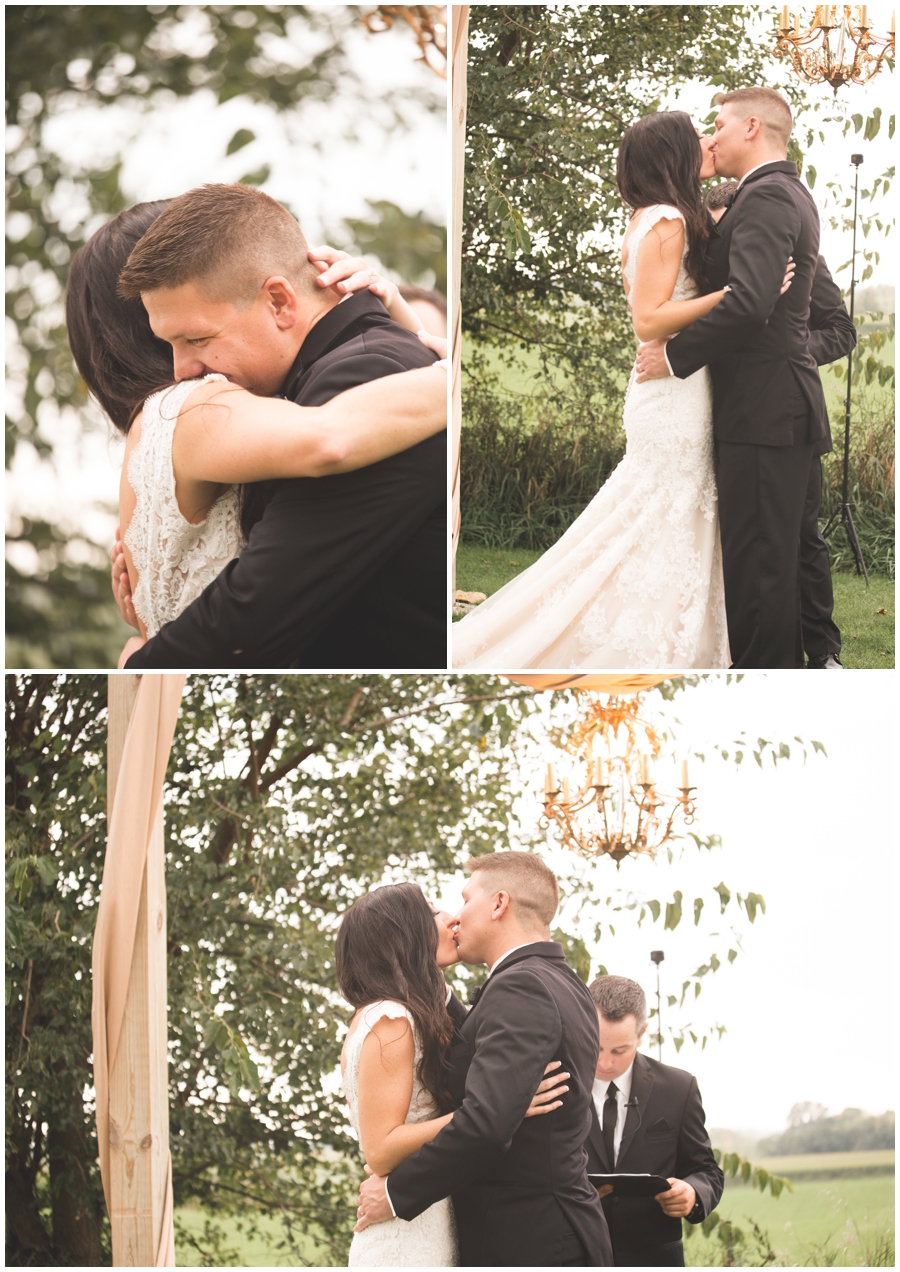  bride and groom kiss at wedding ceremony 