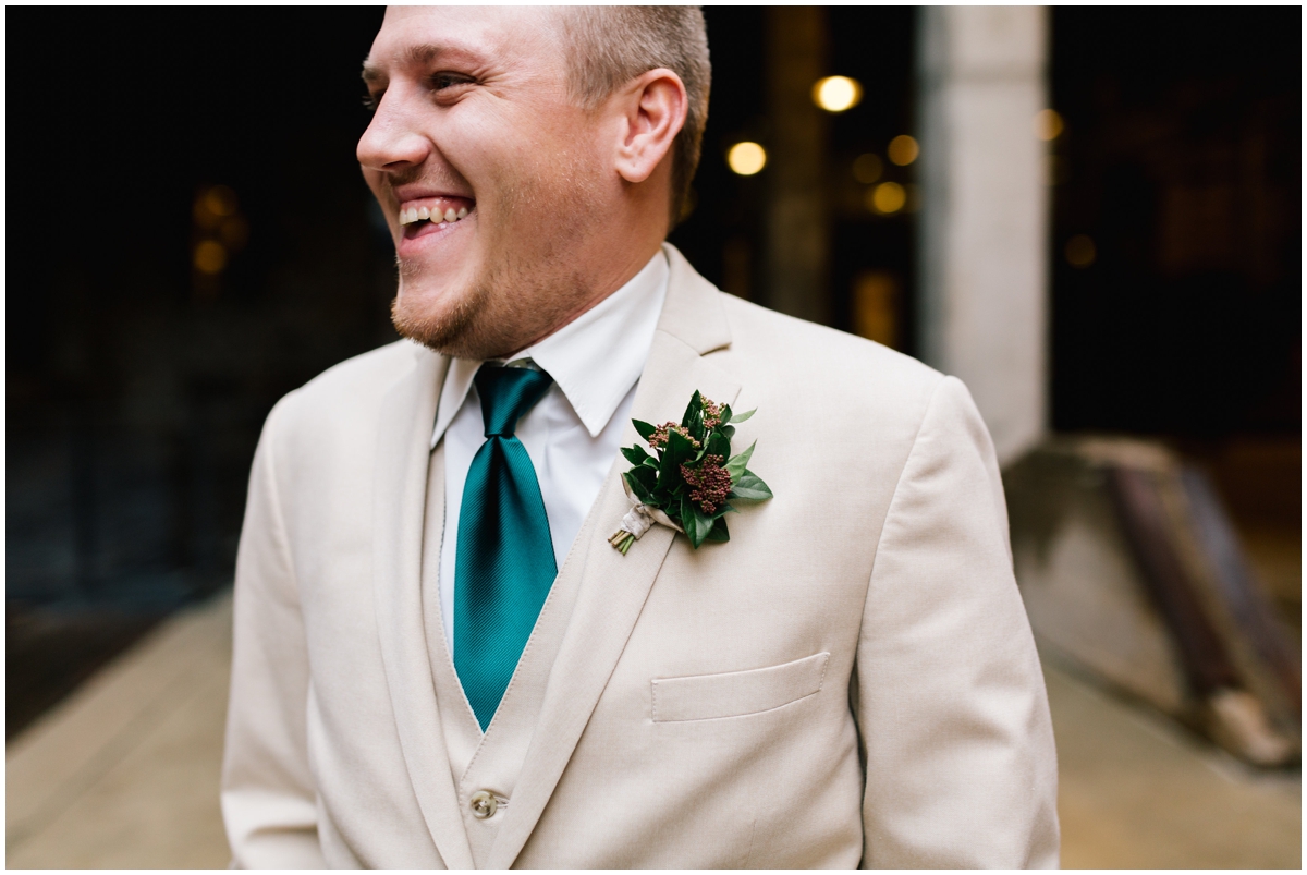 Groom with a greenery tie and boutonneire