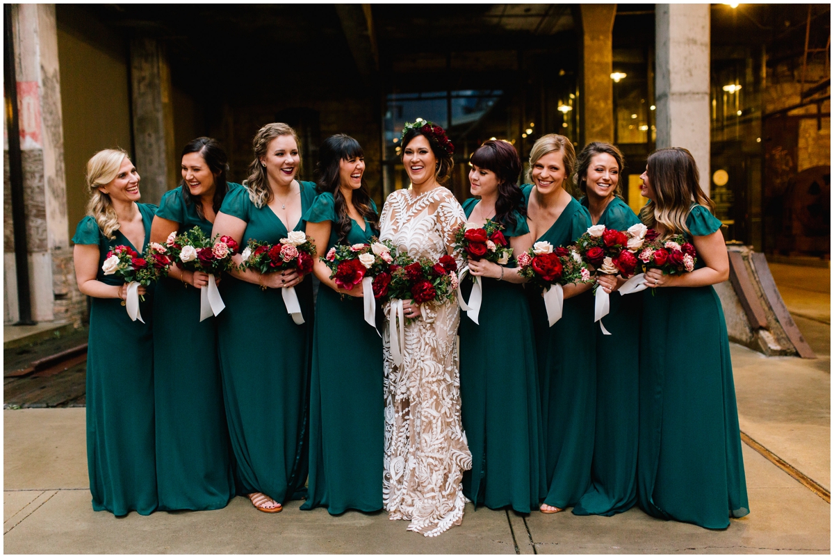  Bride and her bridesmaids with burgundy peony bouquets. 