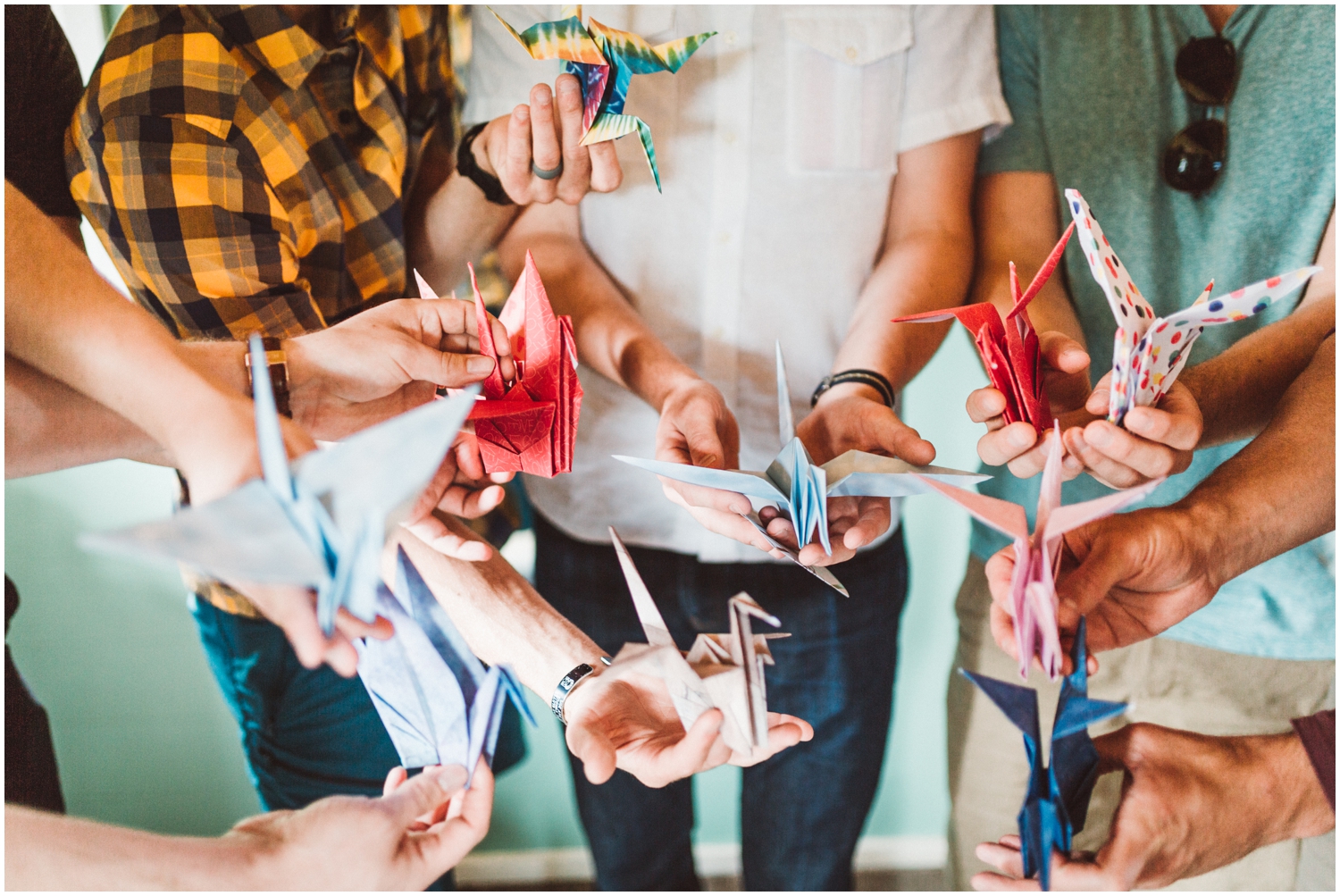 groom and groomsmen making origami for bride surprise
