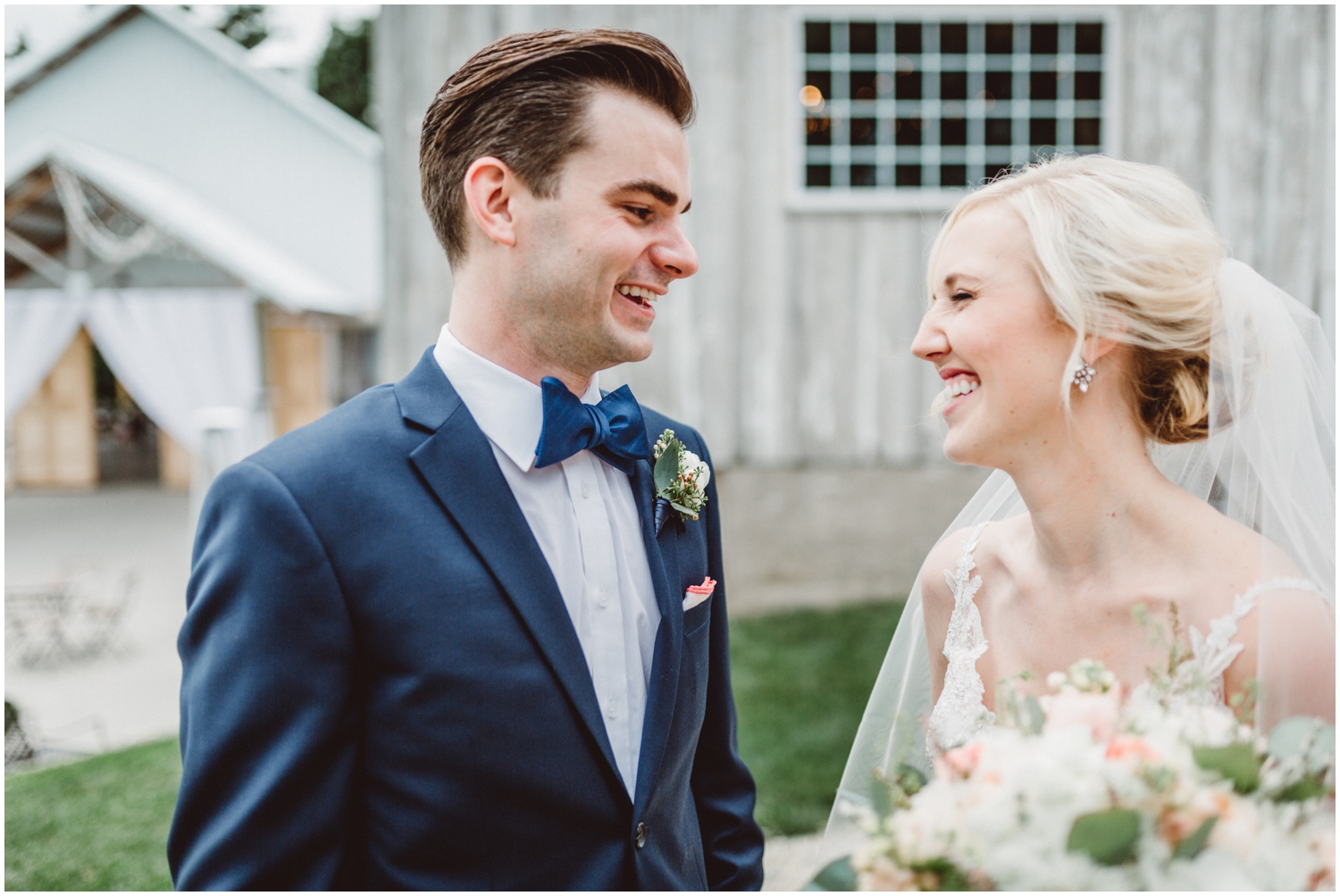 bride and groom smiling at each other