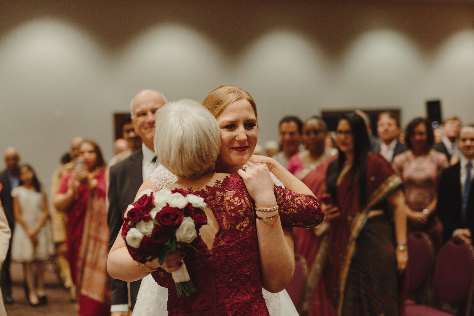  bride hugging guests at wedding 