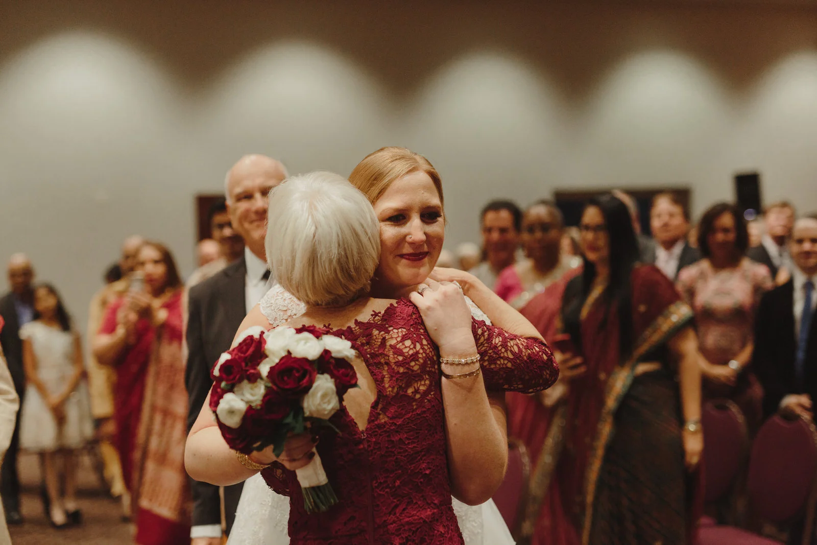 bride hugging guests at wedding