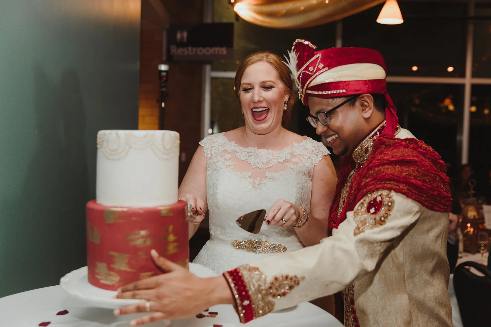 bride and groom cutting their wedding cake together