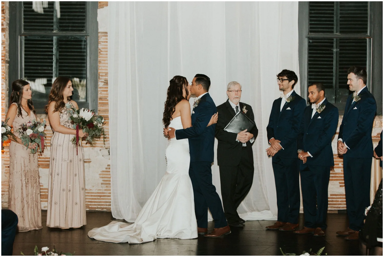 Bride and groom kiss at their wedding ceremony