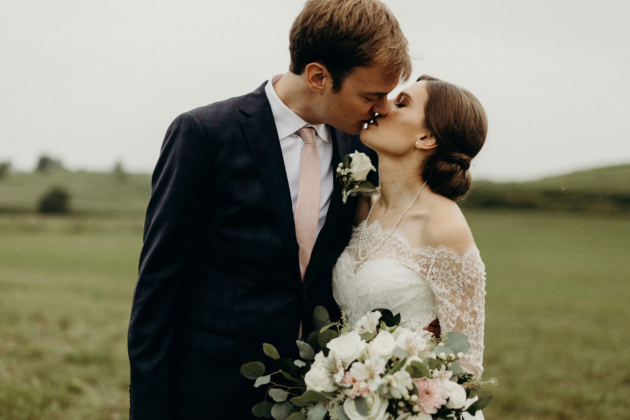 Bride and groom kiss before their wedding