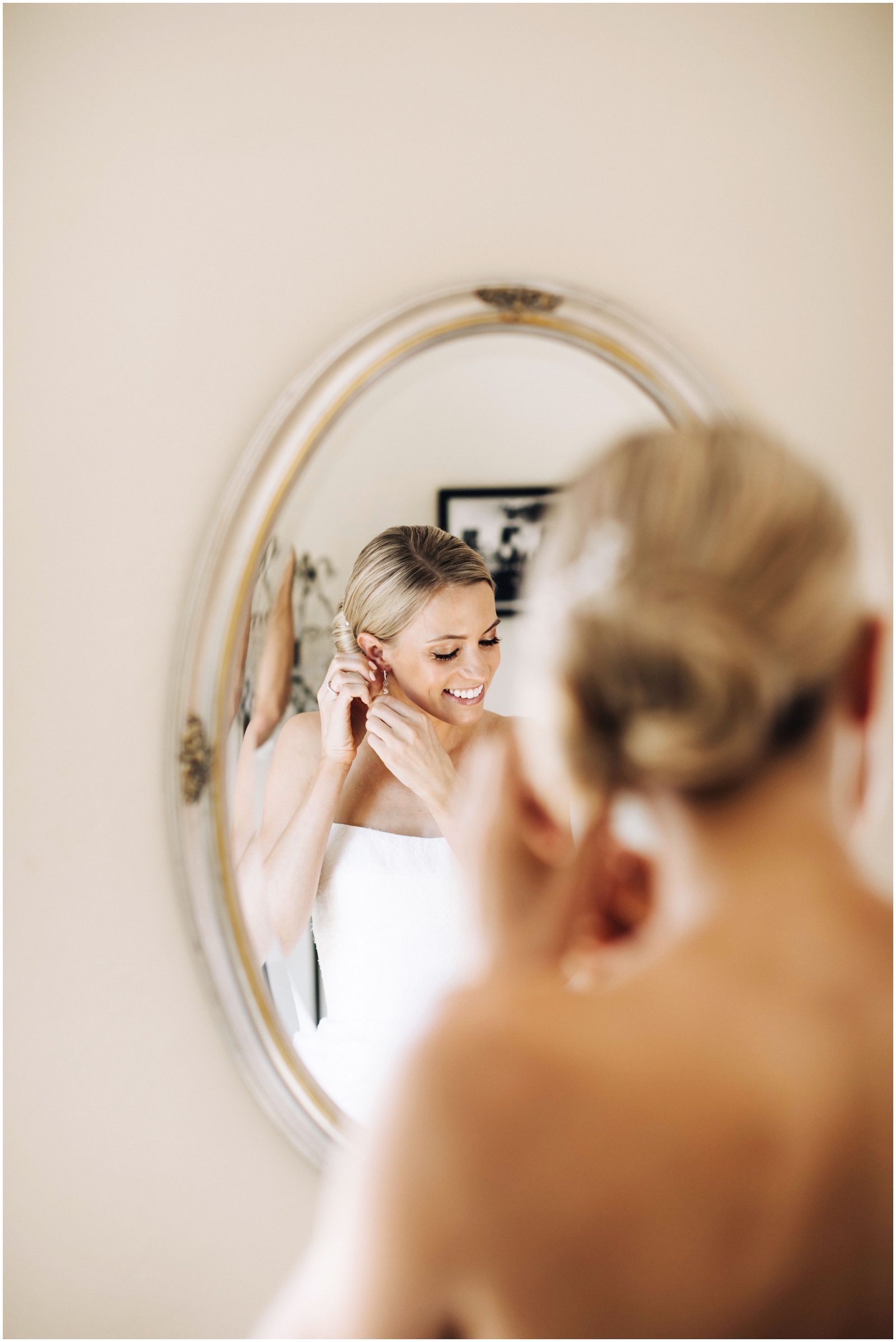  Minnesota Wedding Planner. Lafayette Club Wedding. Bride putting on her earrings 