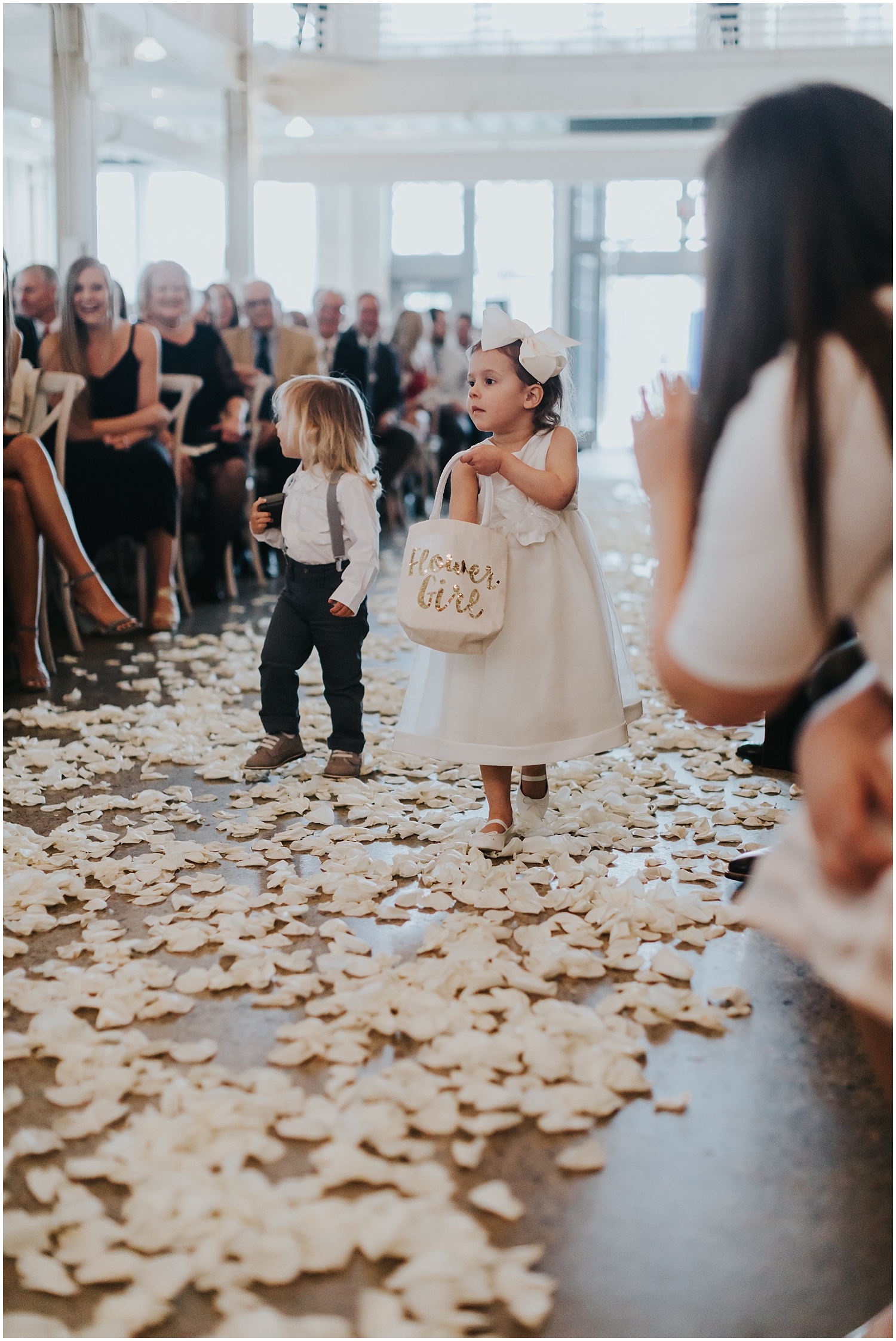  flower girl and ring bearer walking down the aisle 