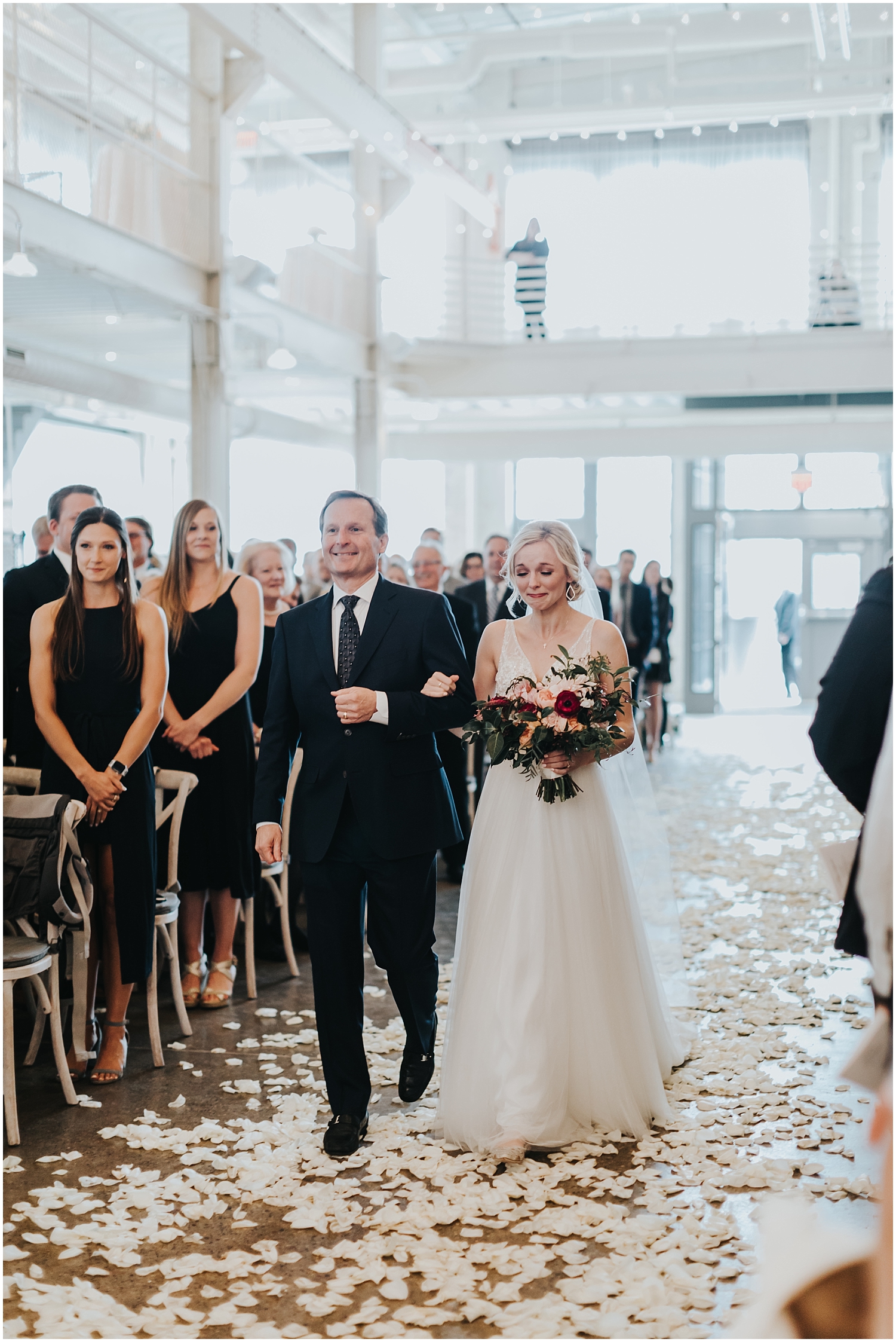 father and bride walking down the aisle