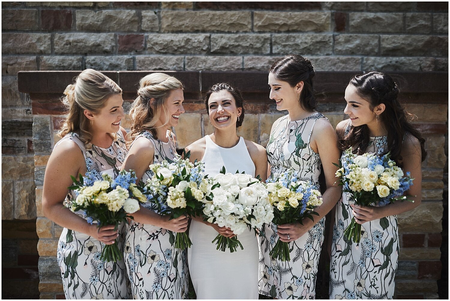  bride with her bridesmaids holding bouquets 