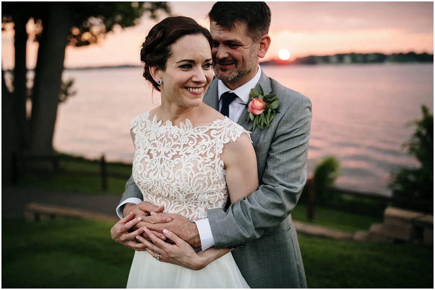 bride and groom hugging during sunset
