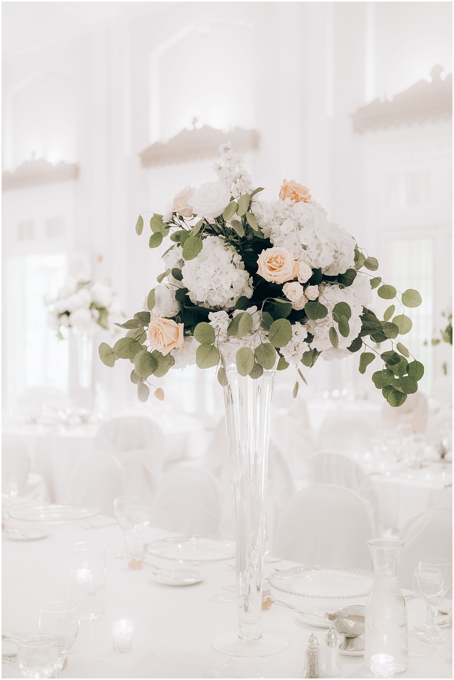  white timeless wedding with floral centerpieces 