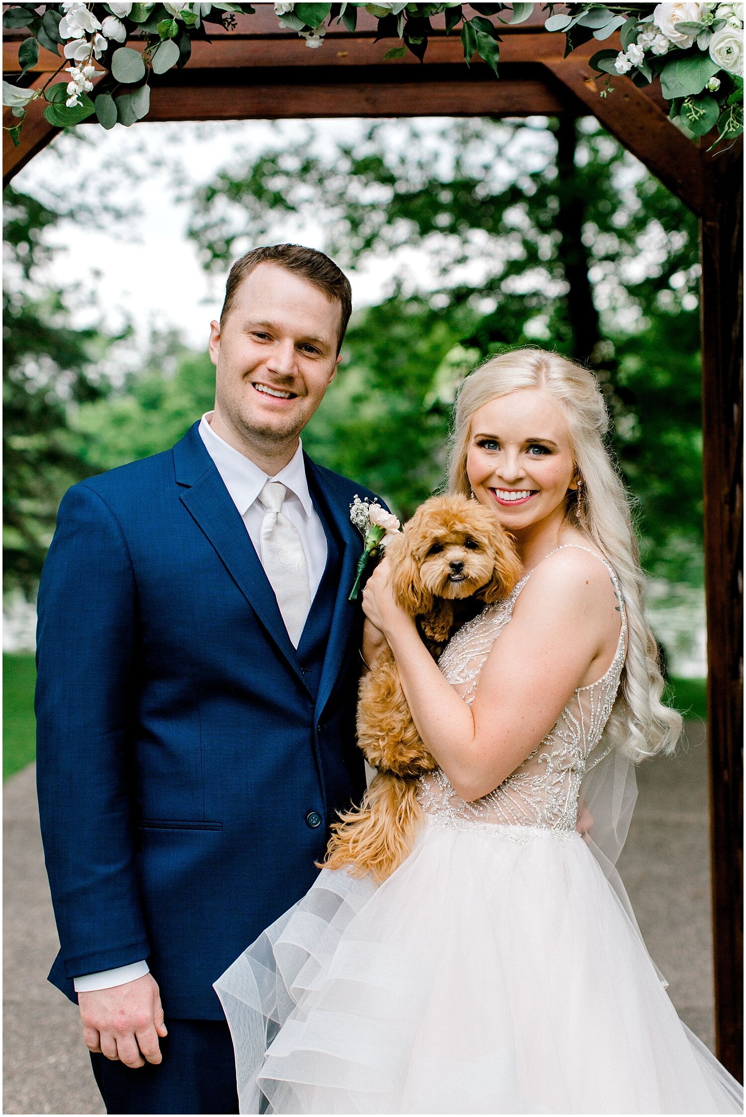  the bride and groom holding their dog before the wedding 
