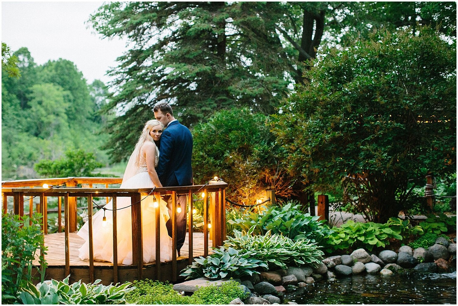  bride and groom portrait on a porch with twinkle lights 