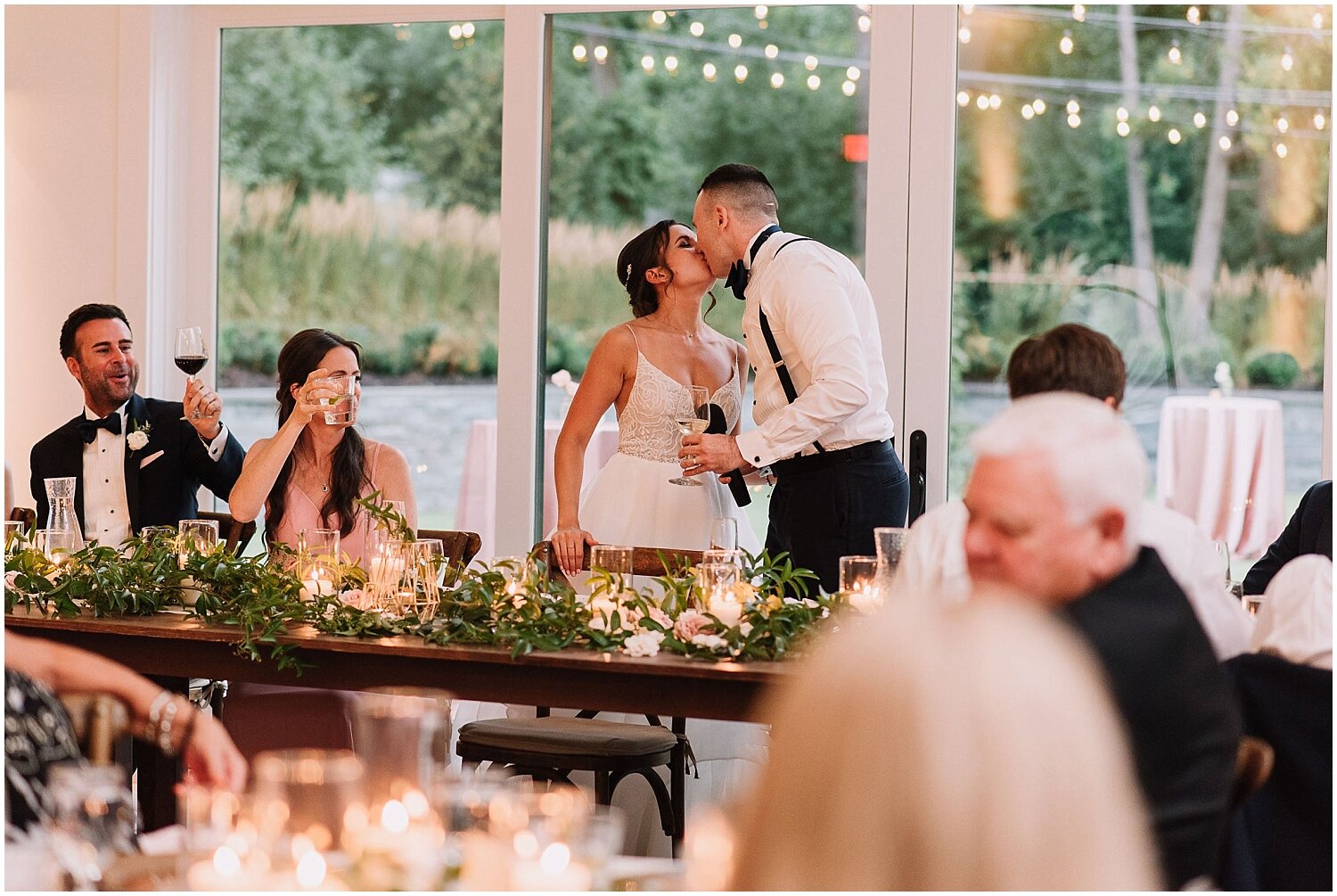  bride and groom kiss at their wedding reception at the Hutton House 