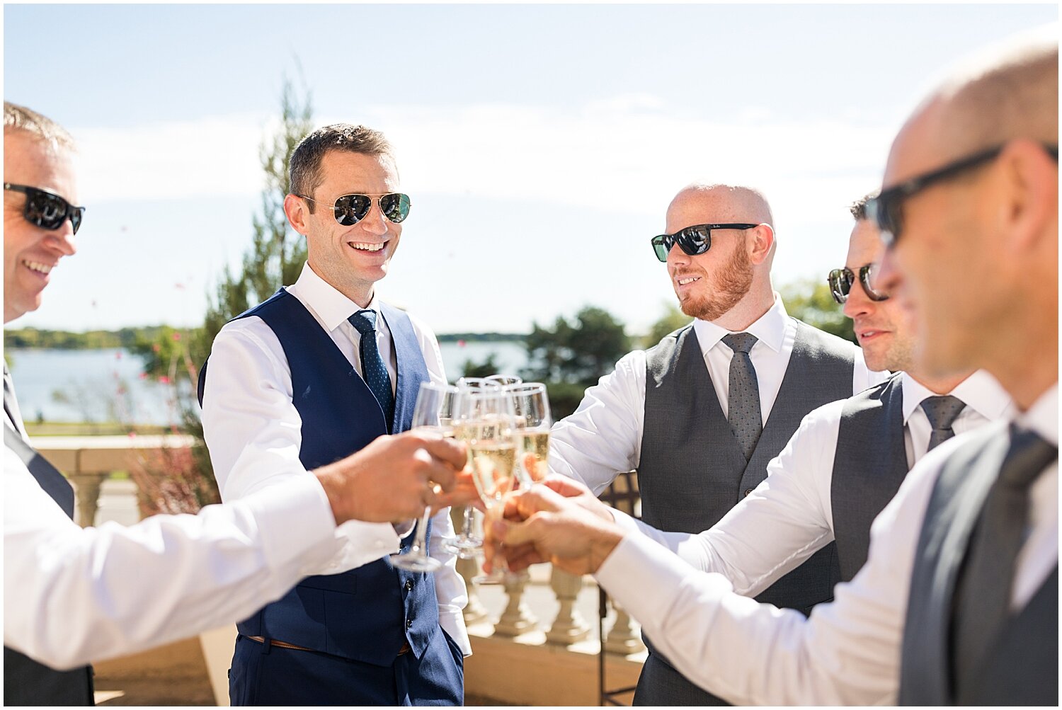  the groom and groomsmen making a toast before the wedding in Calhoun Beach Club 