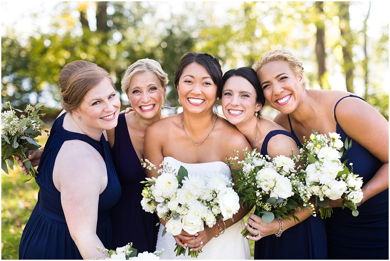  bride and her bridesmaids holding their wedding bouquets 