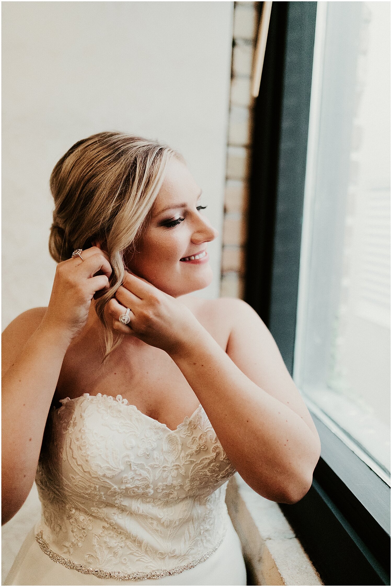  bride putting on her earrings  