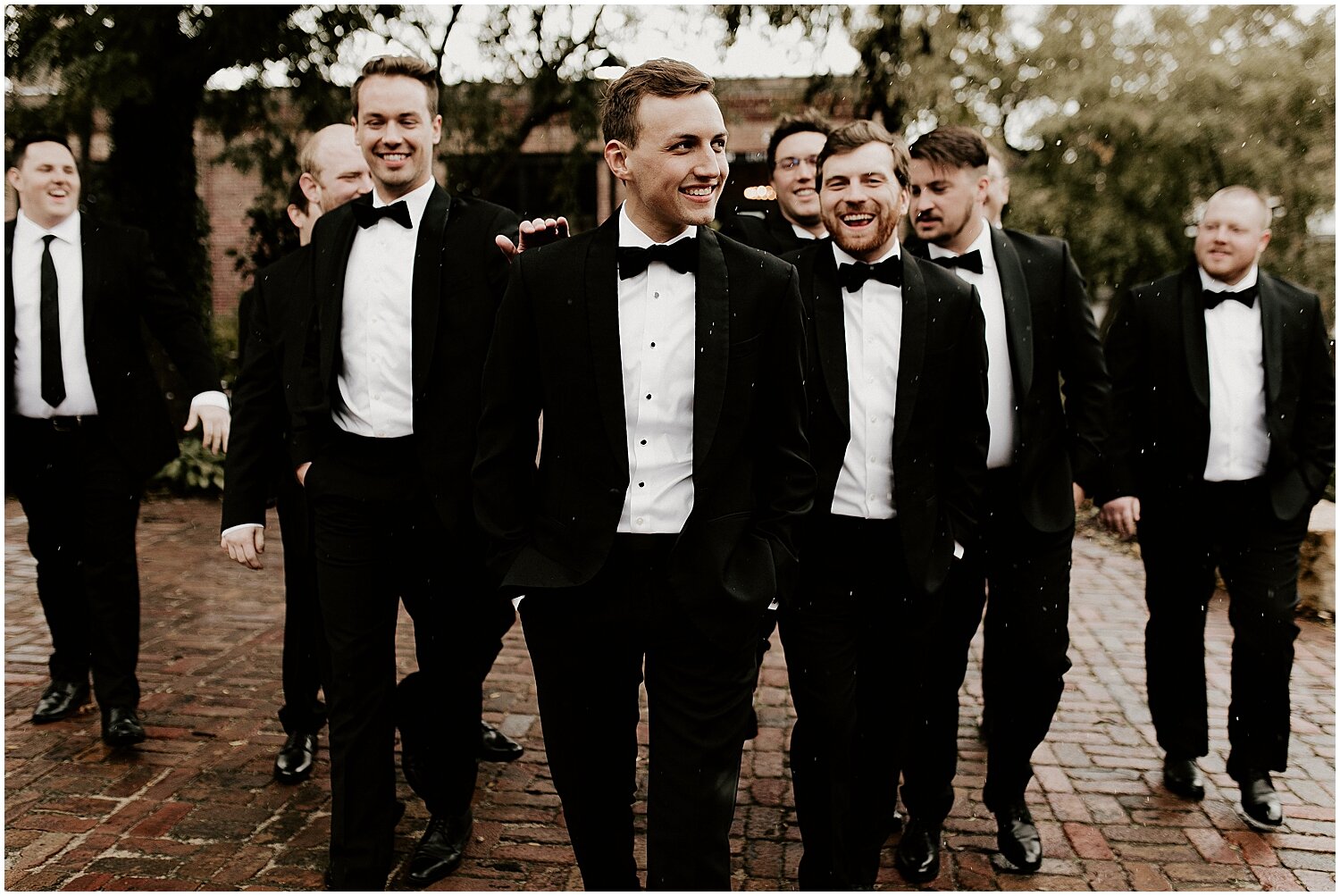  groom and groomsmen pose for photo 