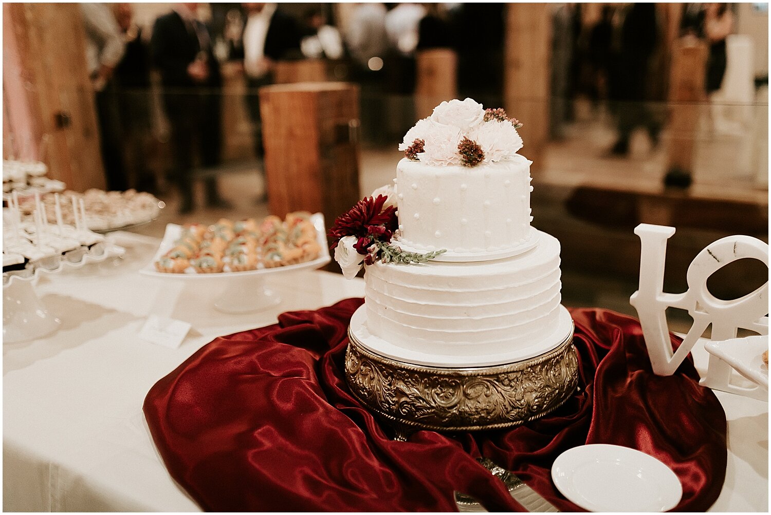  white and maroon wedding cake 