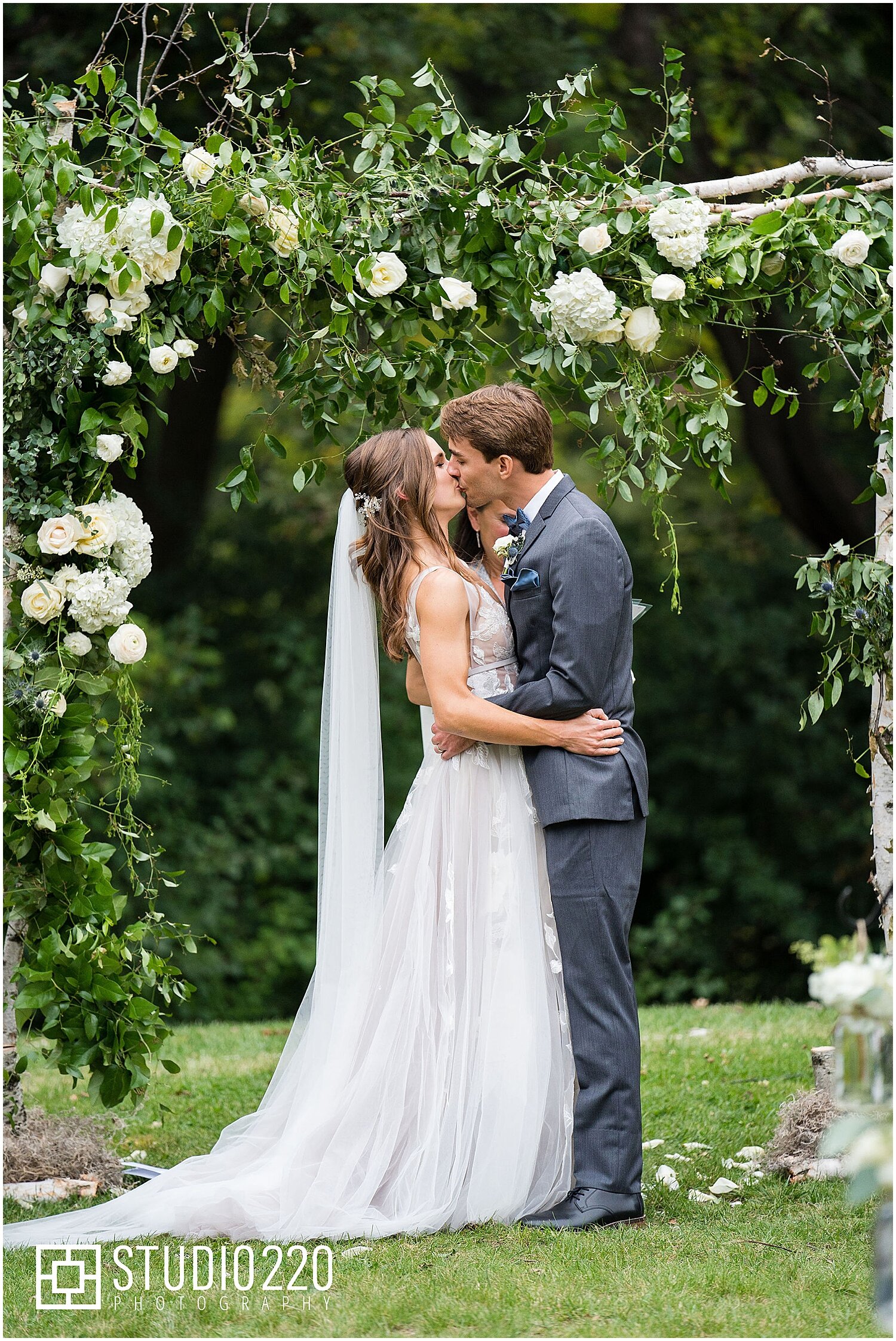  bride and groom kiss after they say I do at their wedding ceremony in Minnesota 