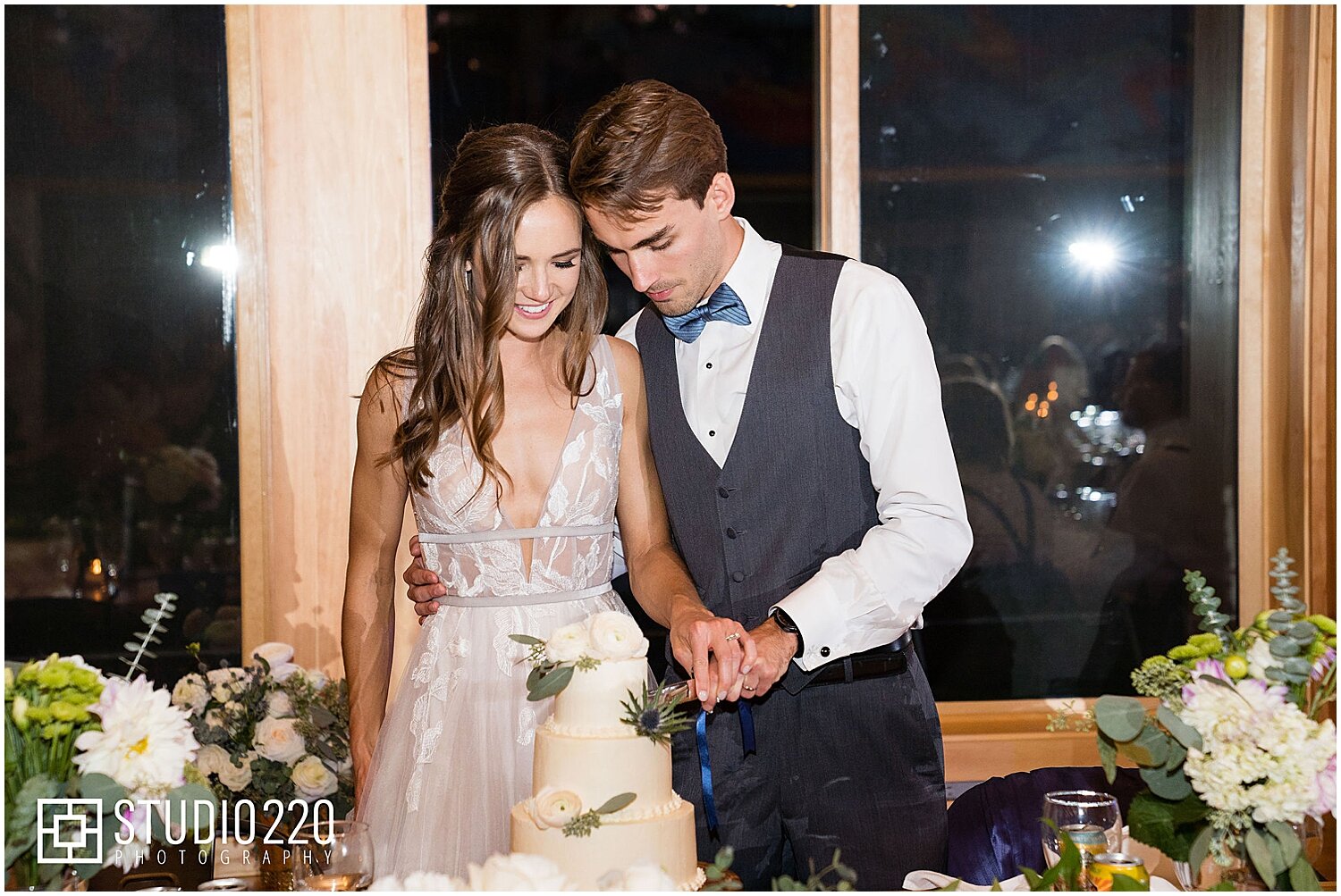  bride and groom cut their wedding cake  