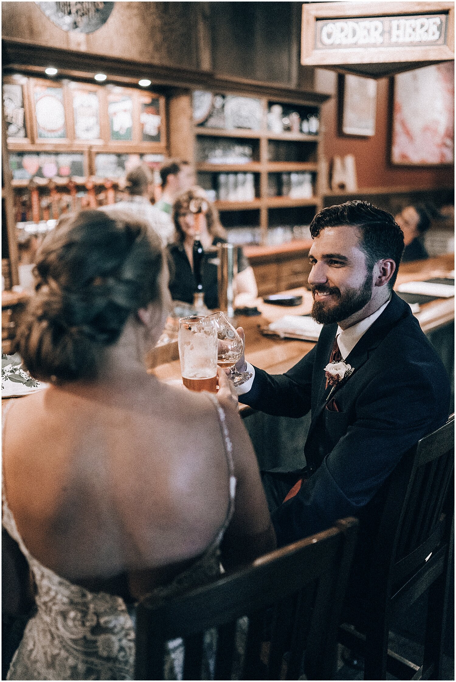  Bride and groom have a glass of beer at their wedding reception 