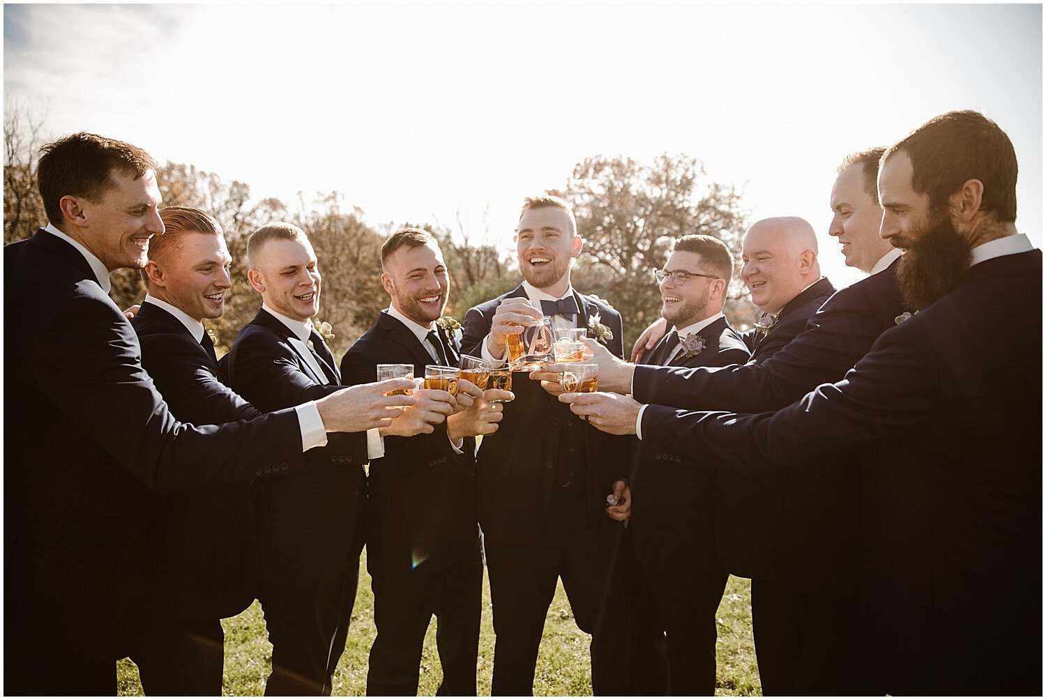  groom and groomsmen making a toast 