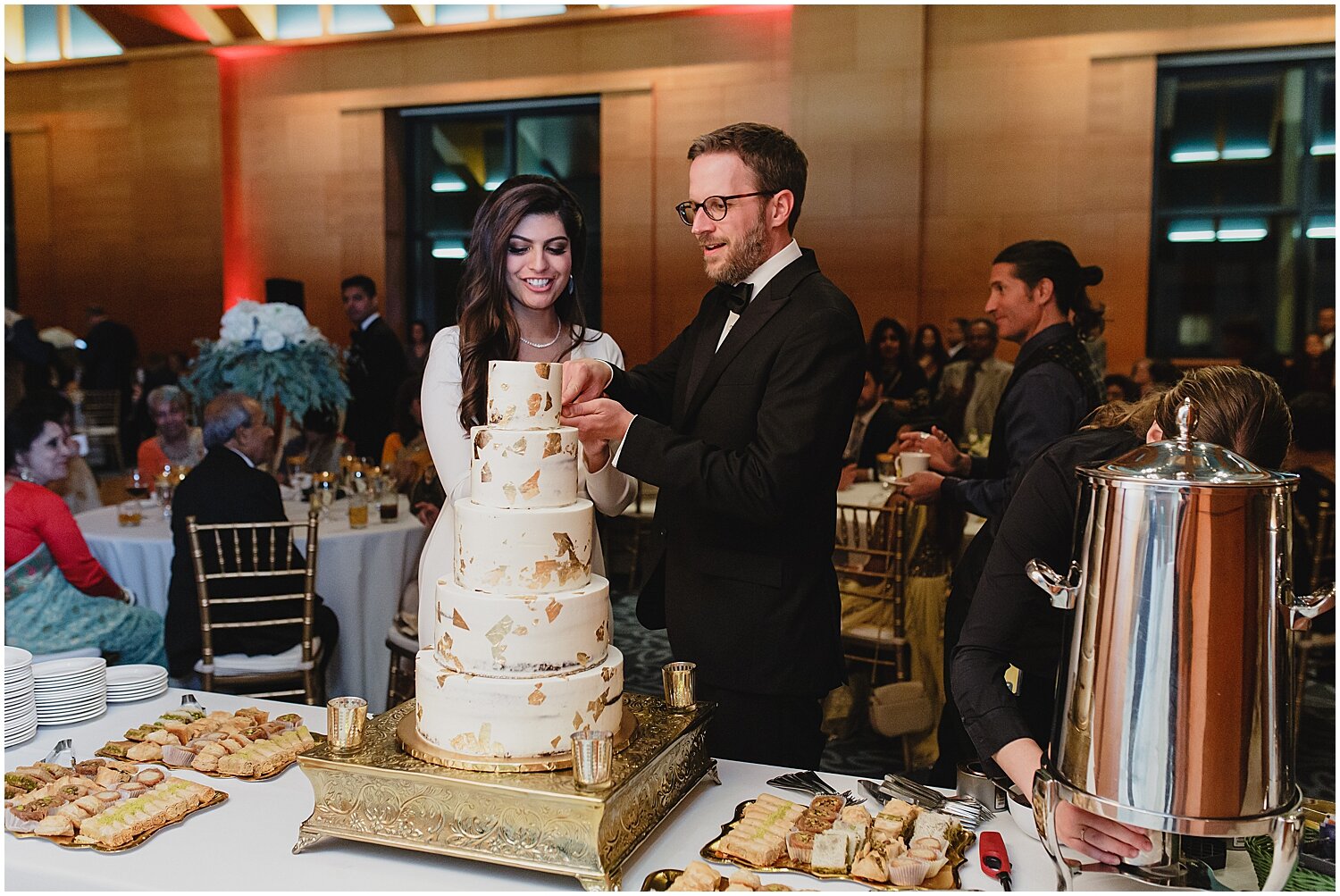  bride and groom cutting their wedding cake 