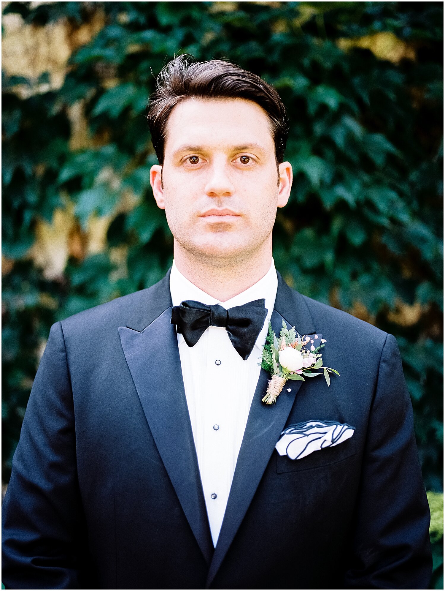  groom looks with his boutonniere 