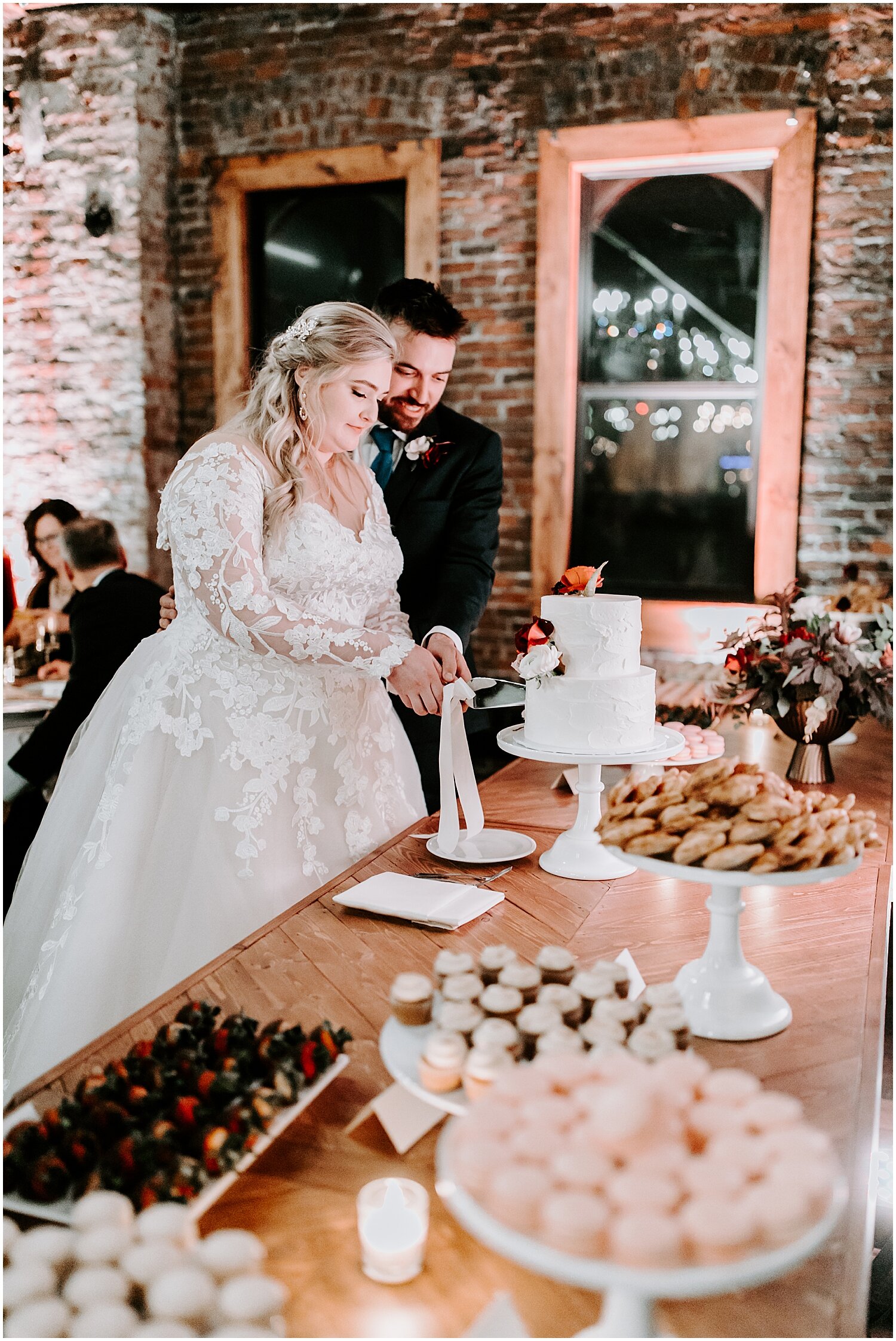  bride and groom cut their wedding cake 