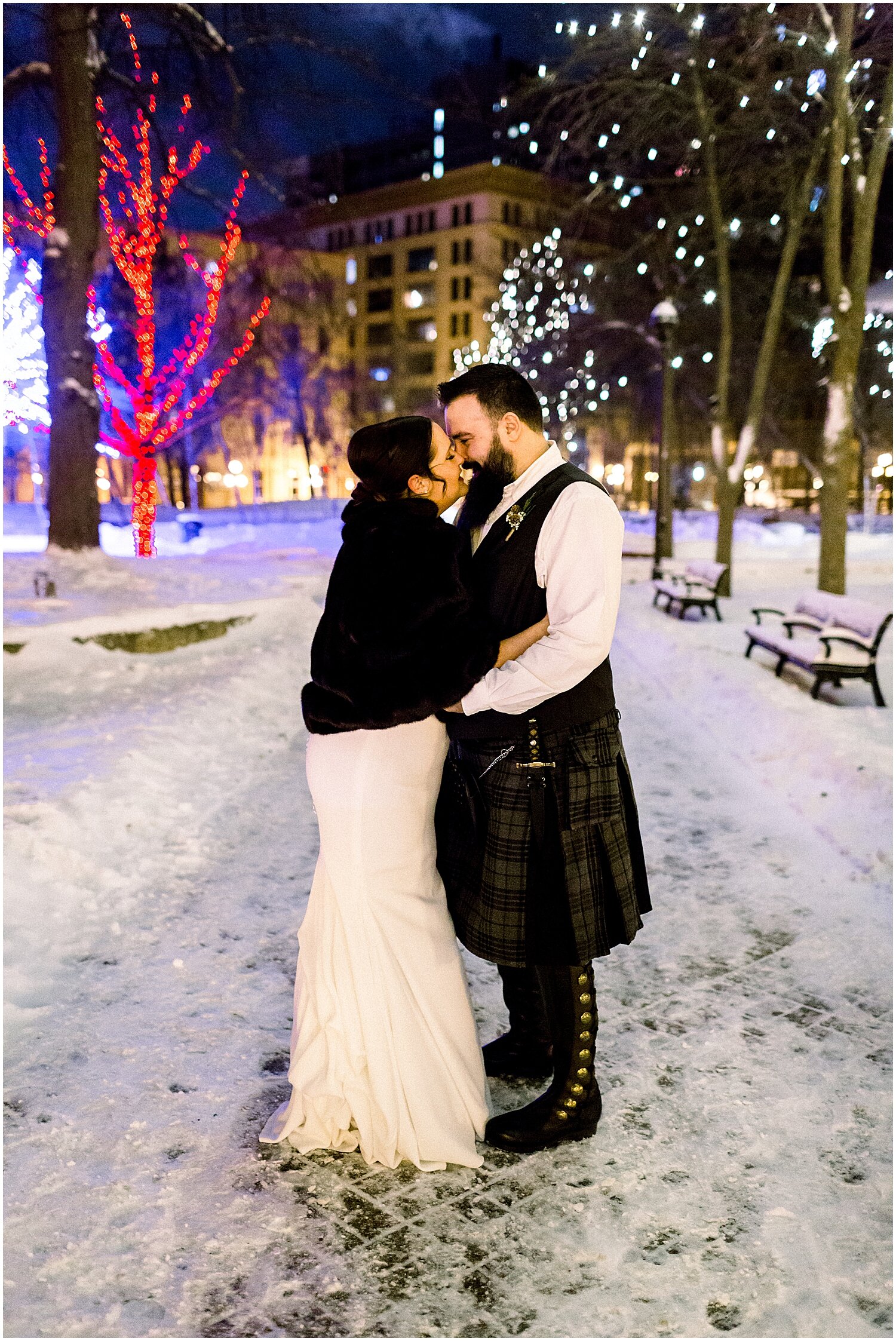  bride and groom kiss during the snowy weather 