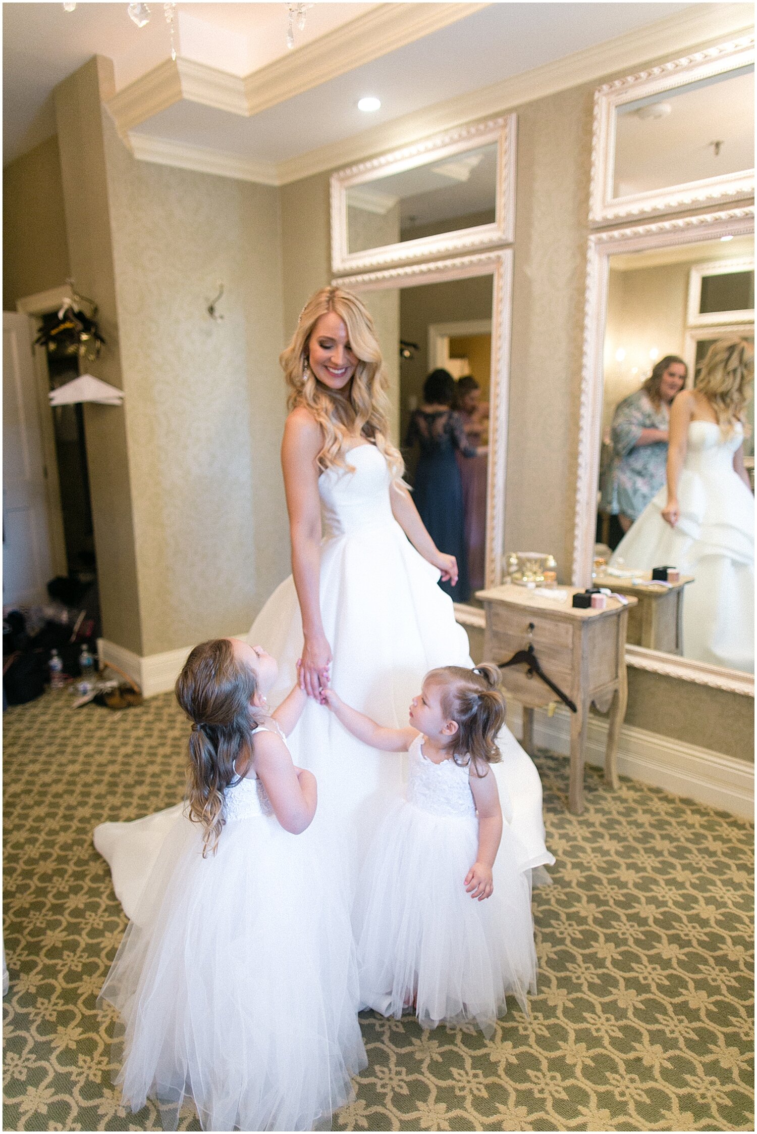  bride getting ready with her flower girls 