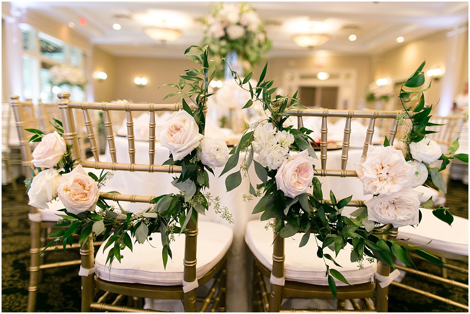  floral decor for bride and grooms chairs 