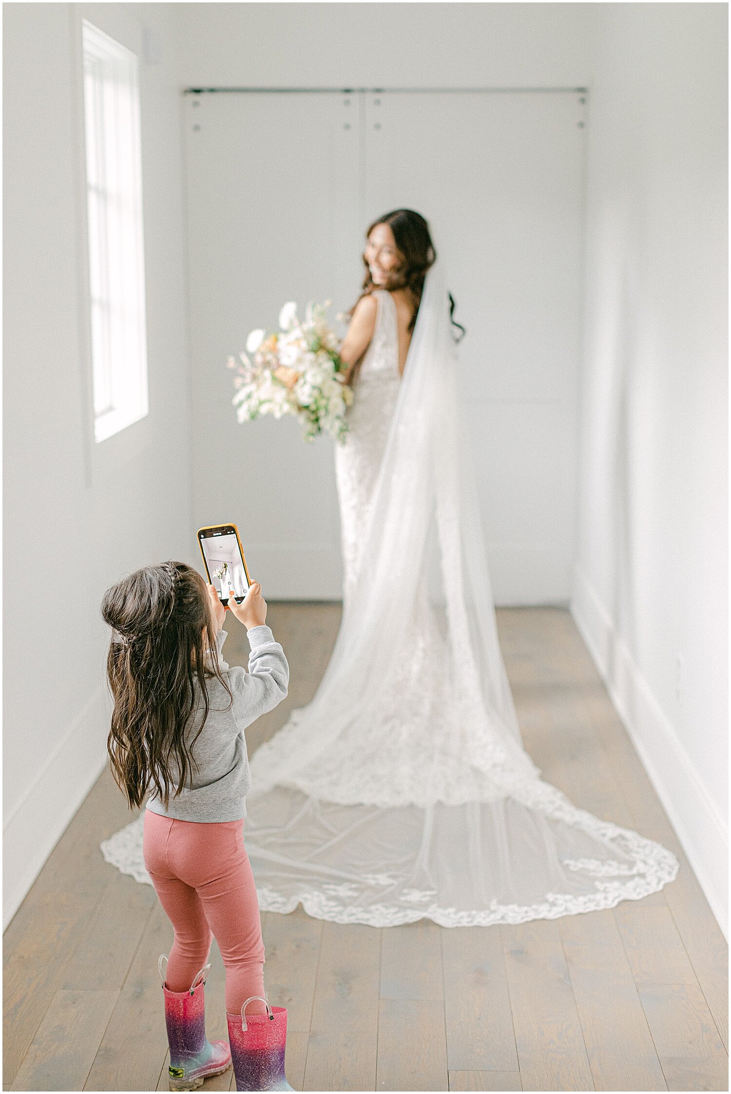  bride getting her picture taken in her wedding dress 
