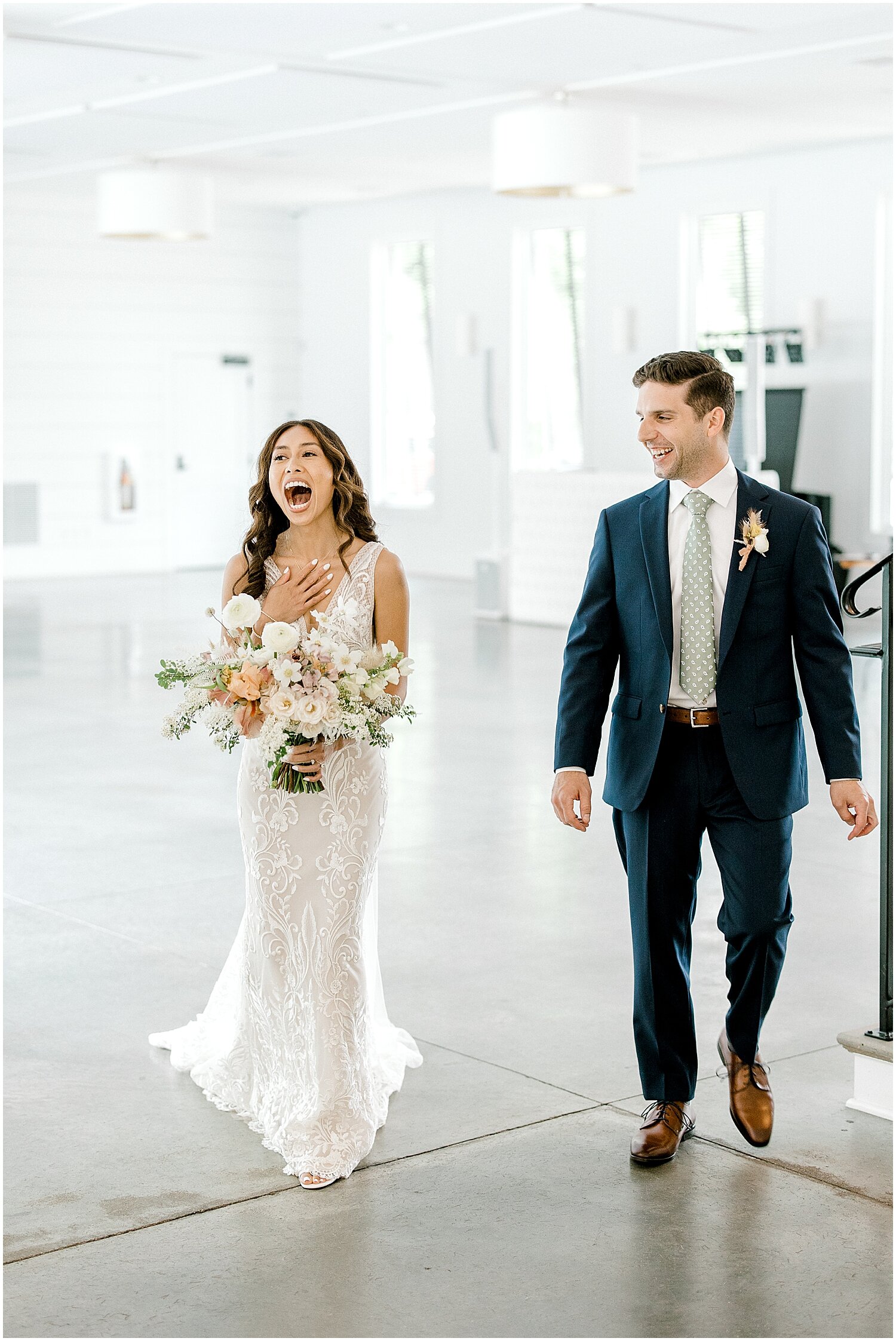  bride and groom walk into their wedding reception for the first time 