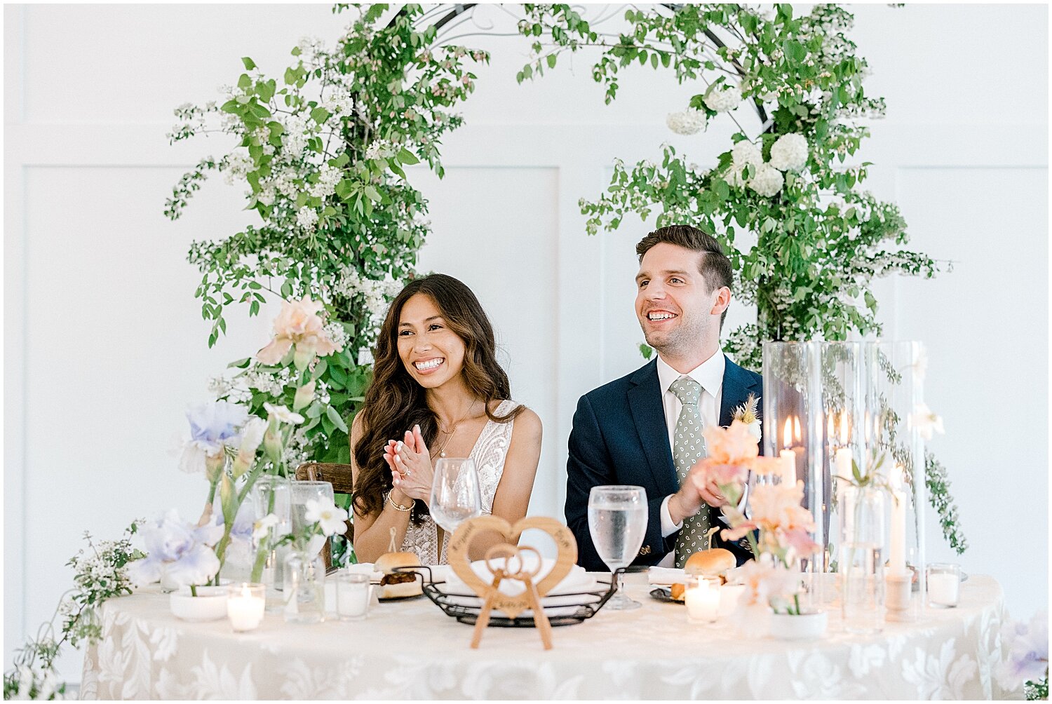  Bride and groom sitting at their sweetheart table 