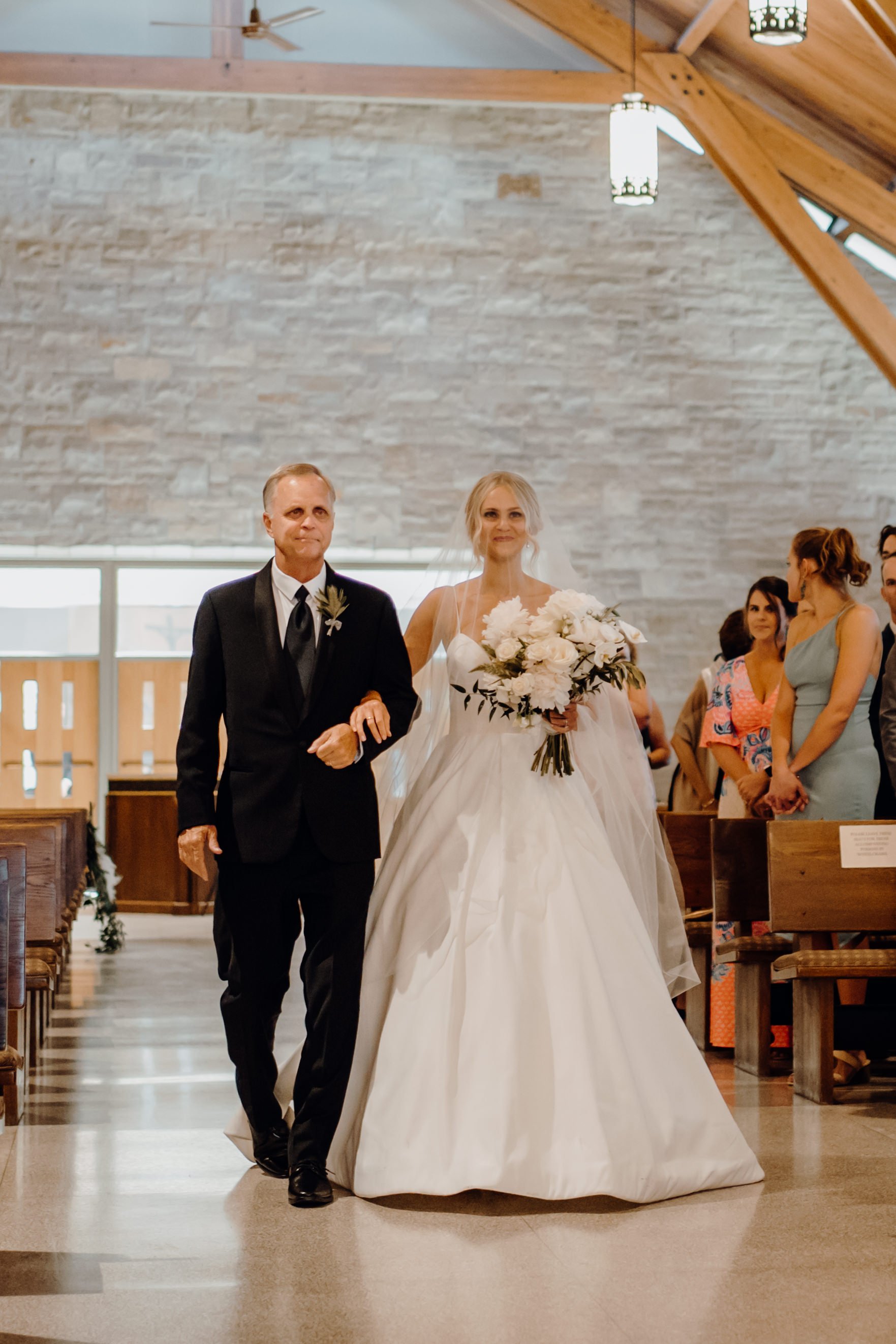  father and bride walking down the aisle 